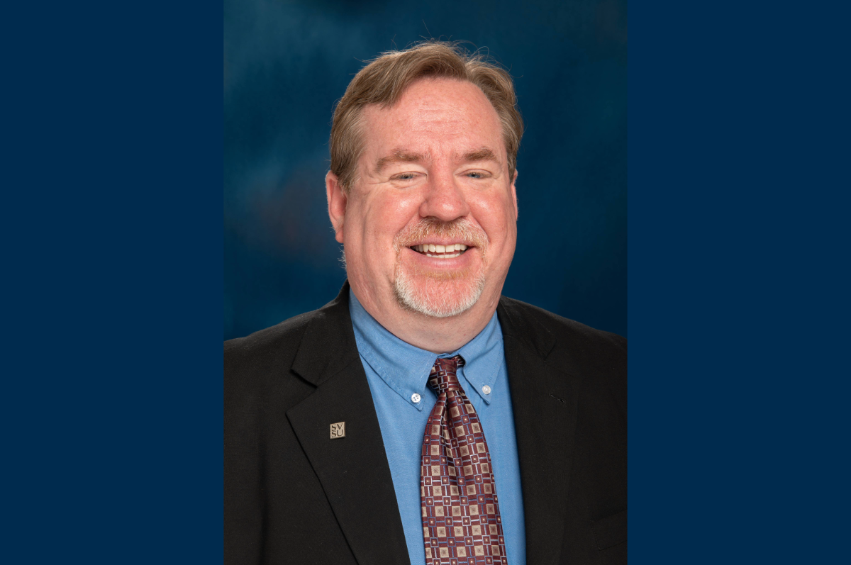 Portrait of man with beard, wearing blue suit